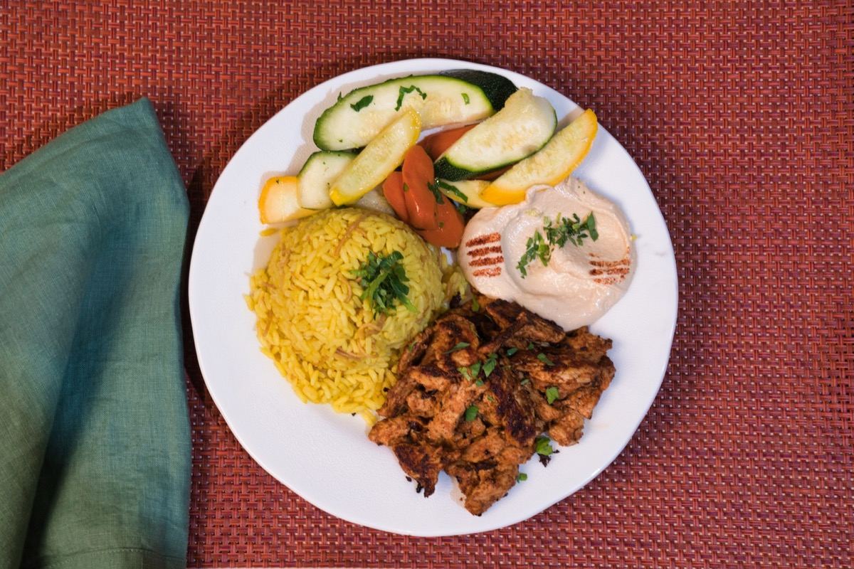 Chicken shawarma family feast platter with rice and vegetables