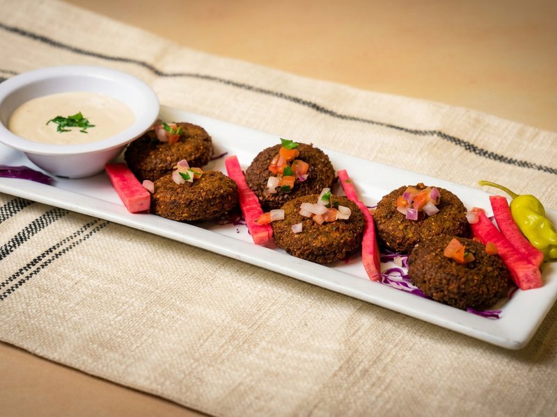 Six pieces of crispy house-made falafel with tahini sauce at Phoenician Garden Fresno