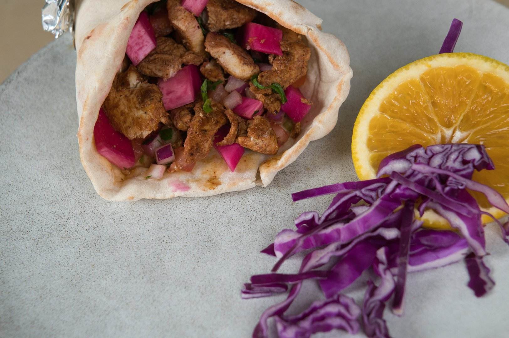 Beef shawarma wrap with tahini and fresh vegetables at Phoenician Garden Fresno